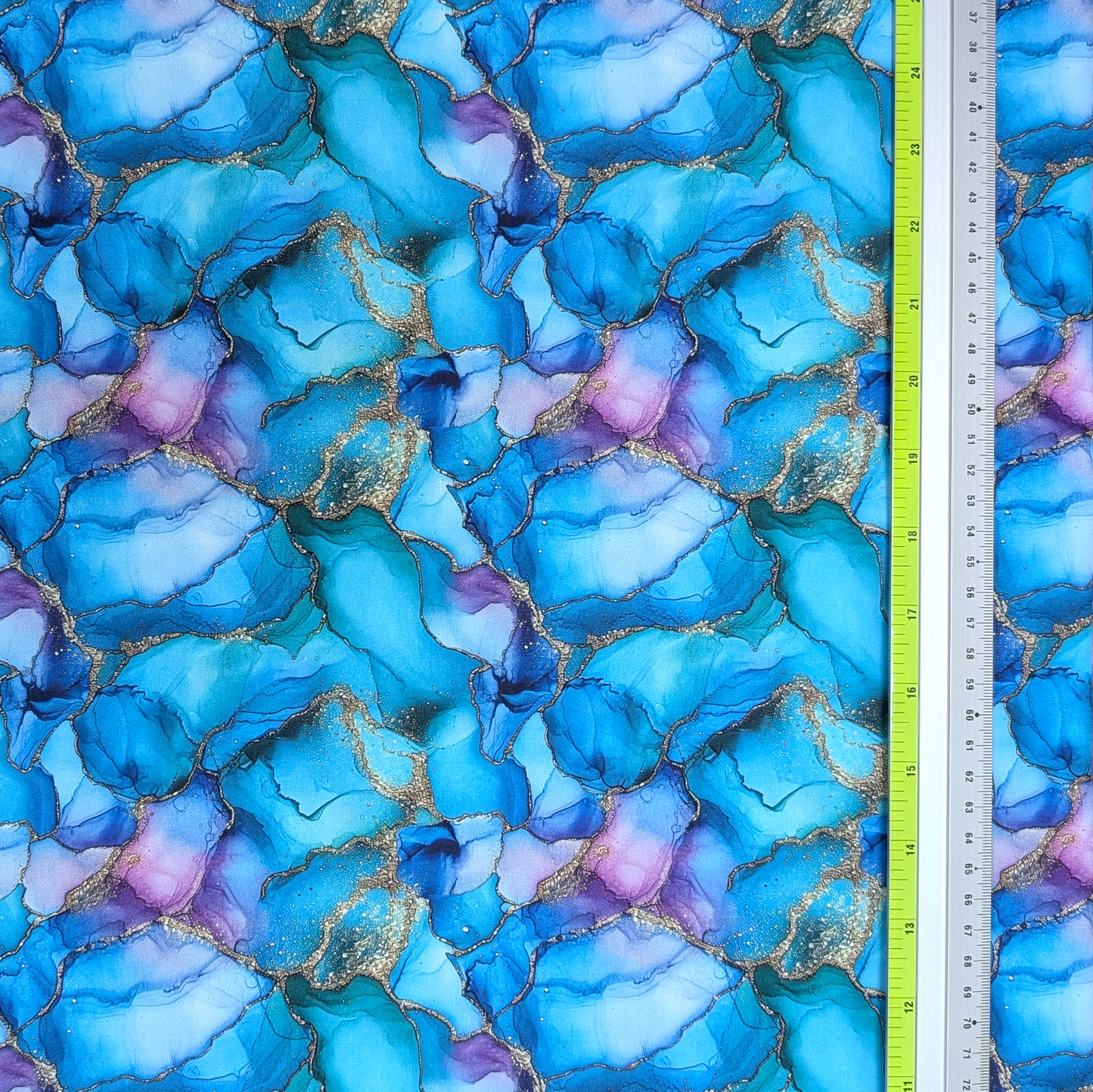 Blue and purple marbled fabric with a ruler for scale